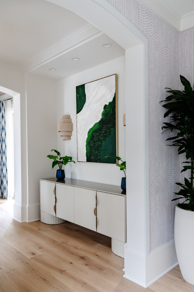 Transitional light wood floor and wallpaper entryway photo