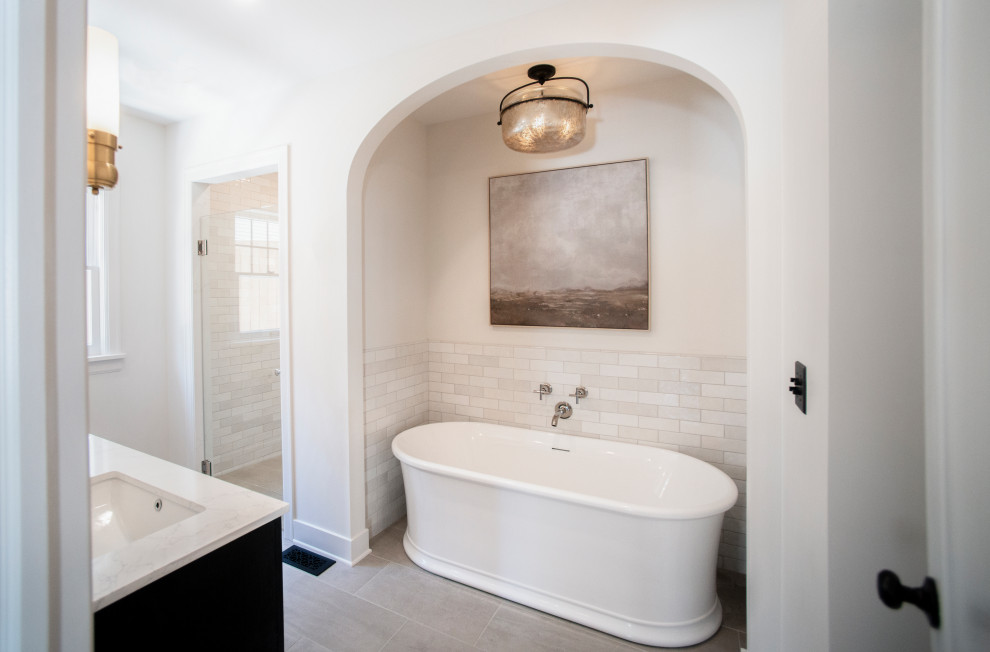 Пример оригинального дизайна: главная ванная комната среднего размера в классическом стиле с черными фасадами, отдельно стоящей ванной, душем без бортиков, желтой плиткой, керамогранитной плиткой, мраморной столешницей, душем с распашными дверями, белой столешницей, тумбой под две раковины и встроенной тумбой