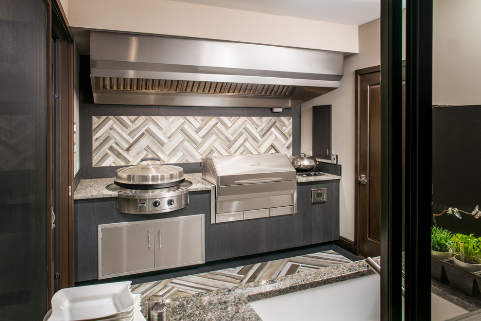 Example of a mid-sized transitional backyard patio kitchen design in Omaha with a roof extension