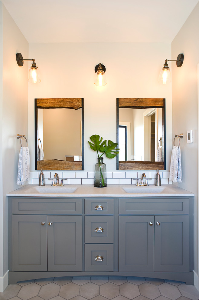 This is an example of a large transitional master bathroom in Other with shaker cabinets, green cabinets, a drop-in tub, an open shower, a two-piece toilet, white tile, subway tile, grey walls, ceramic floors, an integrated sink, onyx benchtops, beige floor, an open shower and white benchtops.