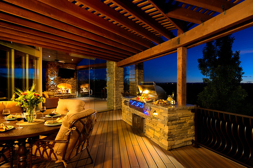 Photo of a large country backyard deck in Los Angeles with an outdoor kitchen and a pergola.