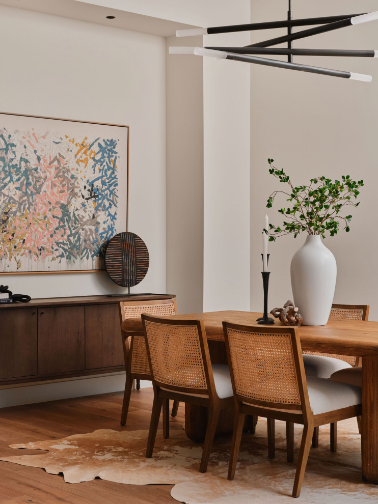 Example of a transitional medium tone wood floor and brown floor dining room design in Austin with white walls