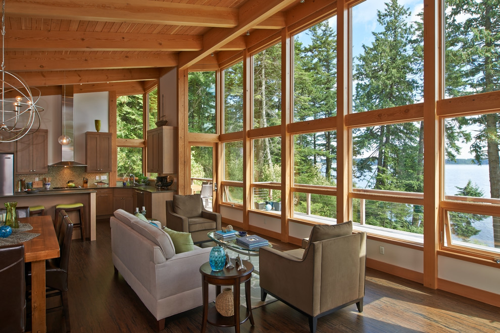 This is an example of a mid-sized country formal open concept living room in Seattle with white walls, dark hardwood floors, no fireplace, no tv and brown floor.