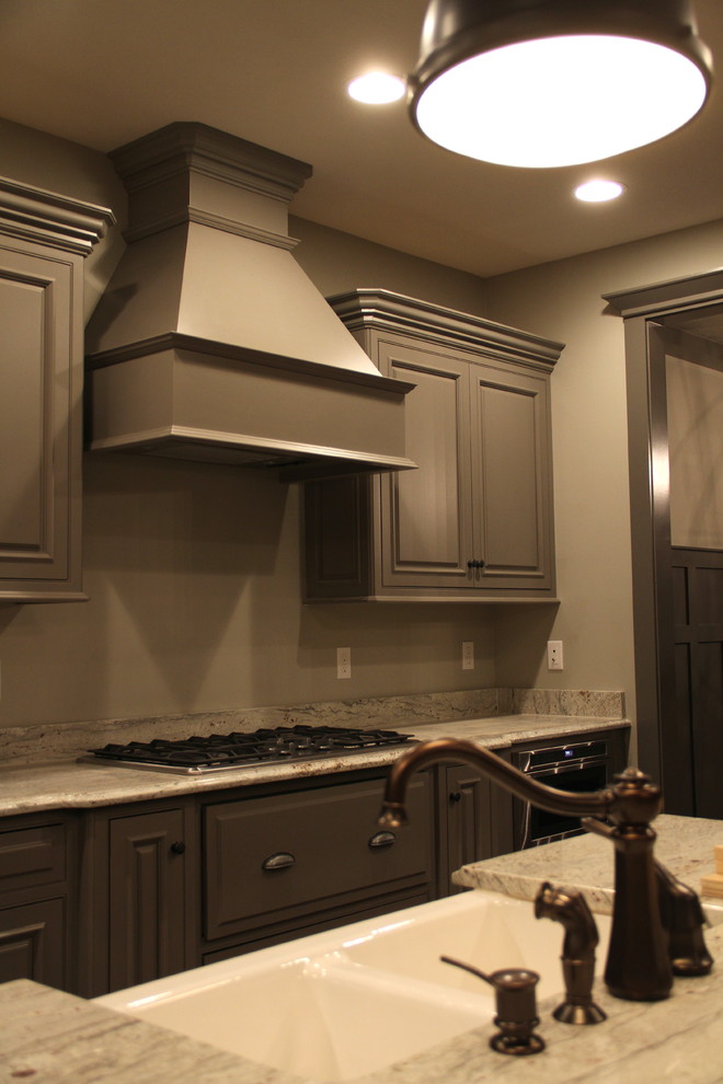 Example of a large mountain style single-wall open concept kitchen design with a farmhouse sink, gray cabinets, granite countertops, stainless steel appliances, an island and shaker cabinets
