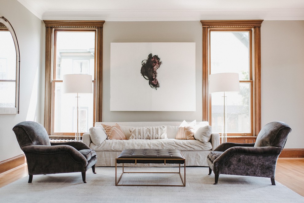 This is an example of a transitional living room in Minneapolis with grey walls, light hardwood floors and beige floor.