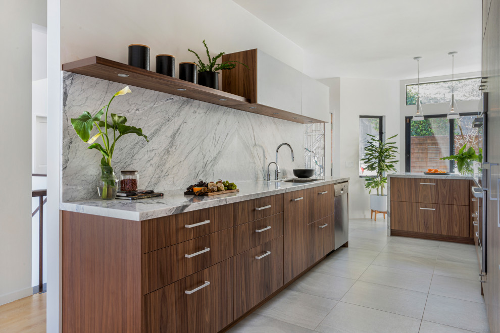 Photo of a small modern galley eat-in kitchen in San Francisco with an undermount sink, flat-panel cabinets, medium wood cabinets, marble benchtops, grey splashback, marble splashback, stainless steel appliances, porcelain floors, a peninsula, grey floor and grey benchtop.