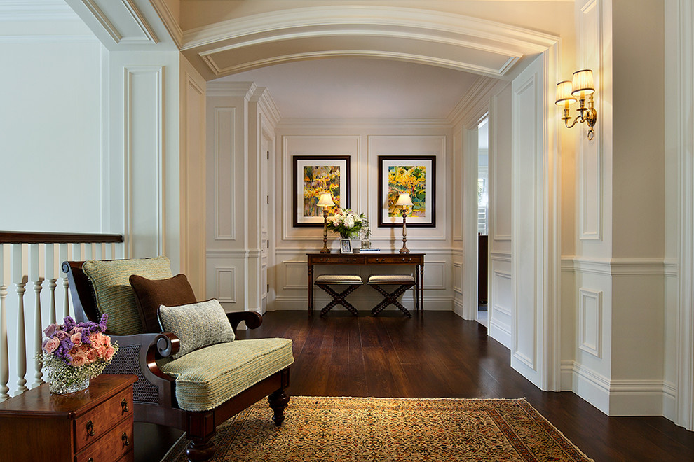 Inspiration for a large traditional hallway in Miami with dark hardwood floors, beige walls and brown floor.