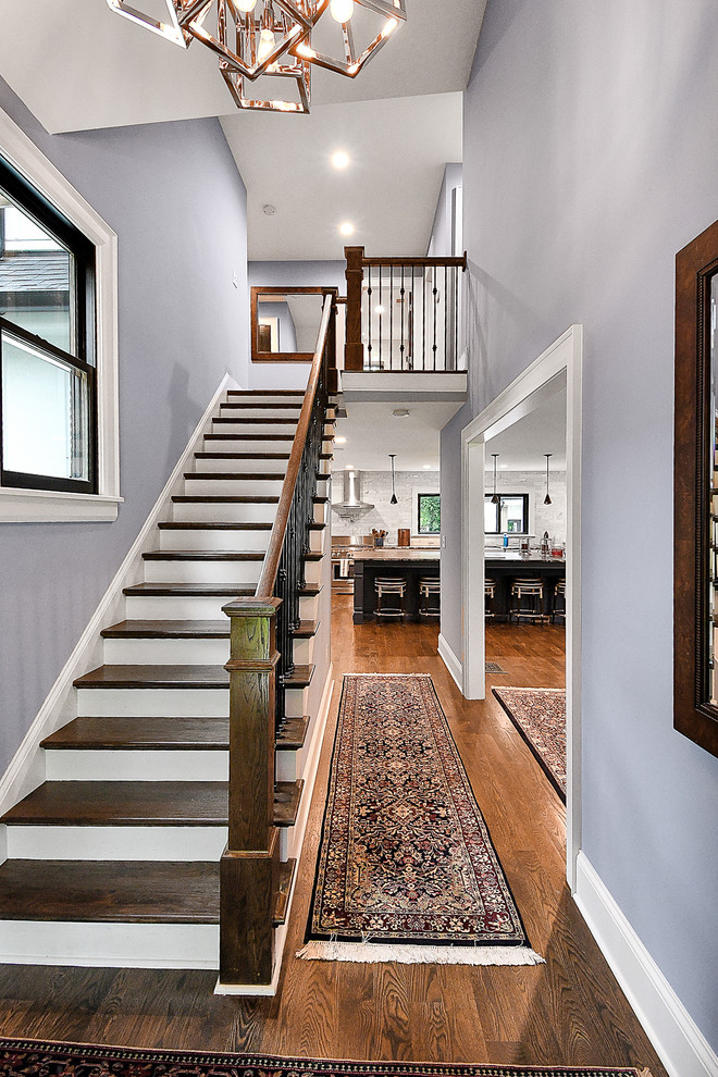 This is an example of a large traditional foyer in Columbus with blue walls, medium hardwood floors, a single front door, a brown front door and brown floor.