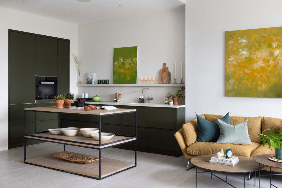 Photo of a medium sized contemporary l-shaped open plan kitchen in London with flat-panel cabinets, grey cabinets, beige splashback, light hardwood flooring, an island and beige worktops.