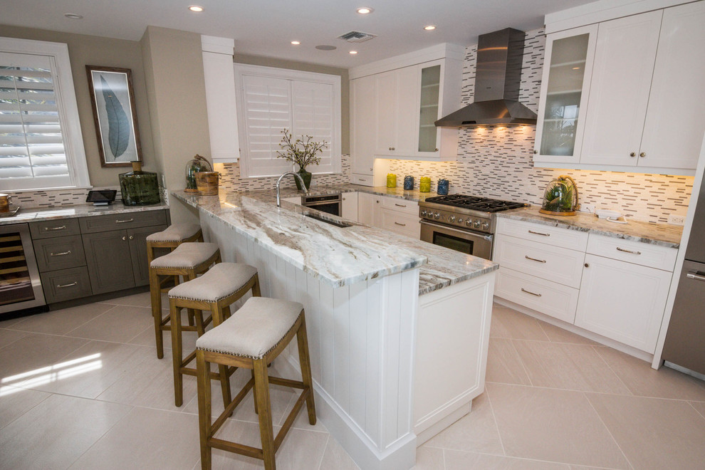 Large transitional u-shaped ceramic tile and beige floor enclosed kitchen photo in Phoenix with an undermount sink, recessed-panel cabinets, white cabinets, marble countertops, multicolored backsplash, matchstick tile backsplash, stainless steel appliances and no island