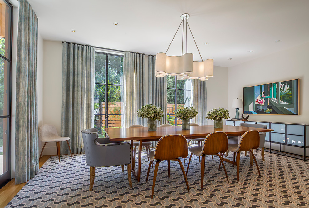 This is an example of a mid-sized midcentury dining room in San Francisco with light hardwood floors.