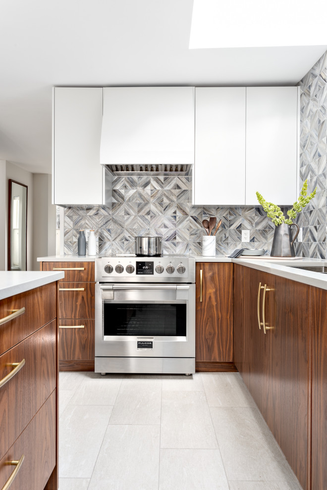 Inspiration for a mid-sized contemporary u-shaped separate kitchen in Vancouver with an undermount sink, flat-panel cabinets, medium wood cabinets, quartz benchtops, multi-coloured splashback, glass tile splashback, stainless steel appliances, porcelain floors, with island, grey floor and white benchtop.