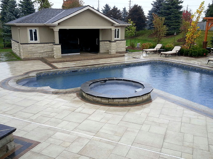 Large transitional backyard stone and l-shaped pool house photo in Toronto