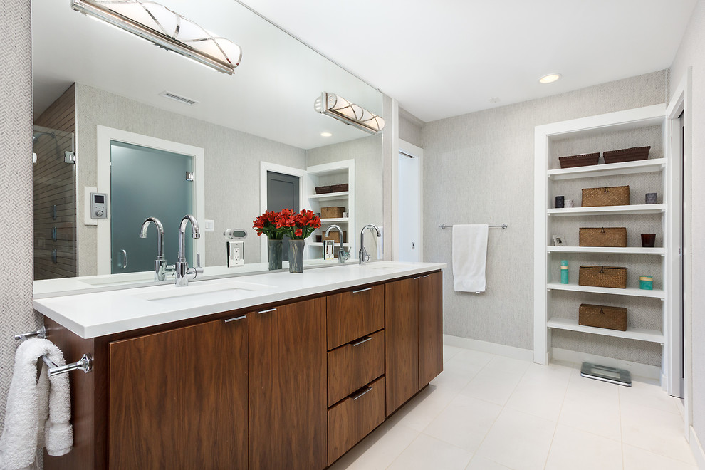 Transitional master beige floor alcove shower photo with flat-panel cabinets, dark wood cabinets, gray walls, an undermount sink, a hinged shower door and white countertops