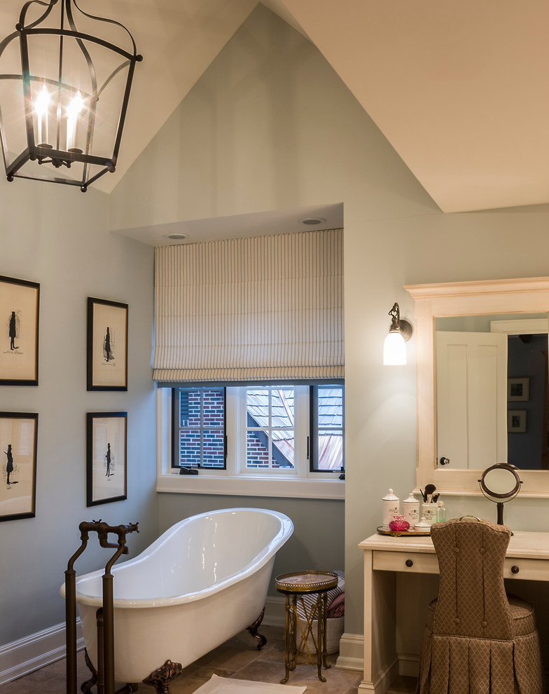 Inspiration for a large country master bathroom in Chicago with an undermount sink, raised-panel cabinets, white cabinets, limestone benchtops, a claw-foot tub, blue walls and marble floors.