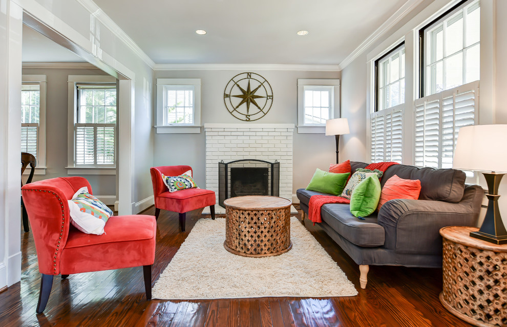 This is an example of an arts and crafts living room in DC Metro with a brick fireplace surround.