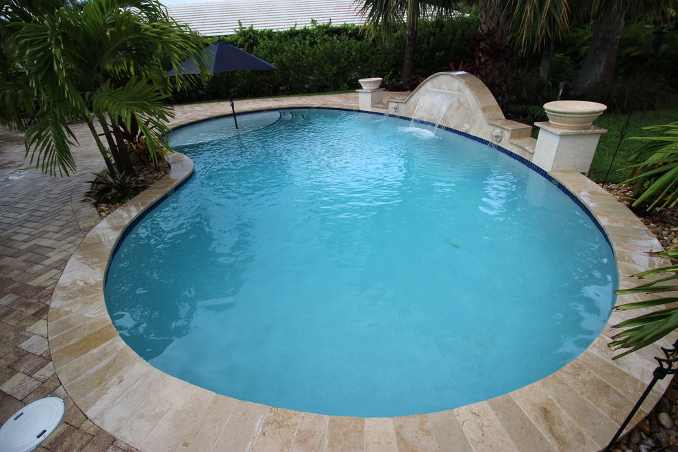 Pool fountain - mid-sized transitional backyard brick and custom-shaped natural pool fountain idea in Miami