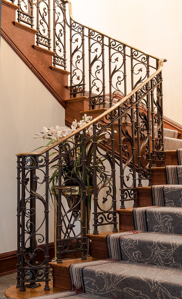Design ideas for a mid-sized traditional carpeted u-shaped staircase in Denver with carpet risers.