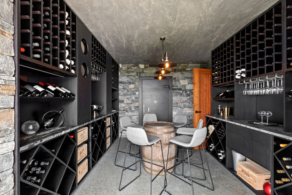 This is an example of a mid-sized contemporary wine cellar in Sunshine Coast with concrete floors.
