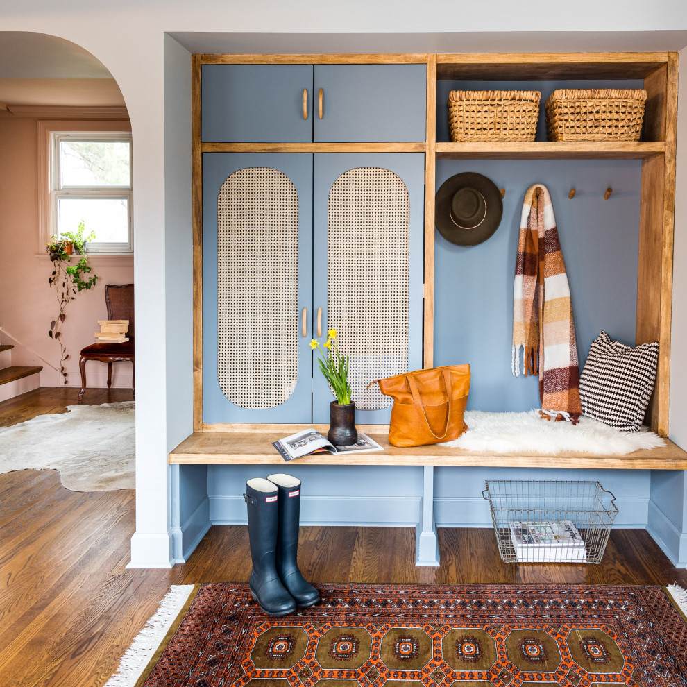 This is an example of a mid-sized transitional mudroom in Chicago with blue walls, medium hardwood floors and brown floor.