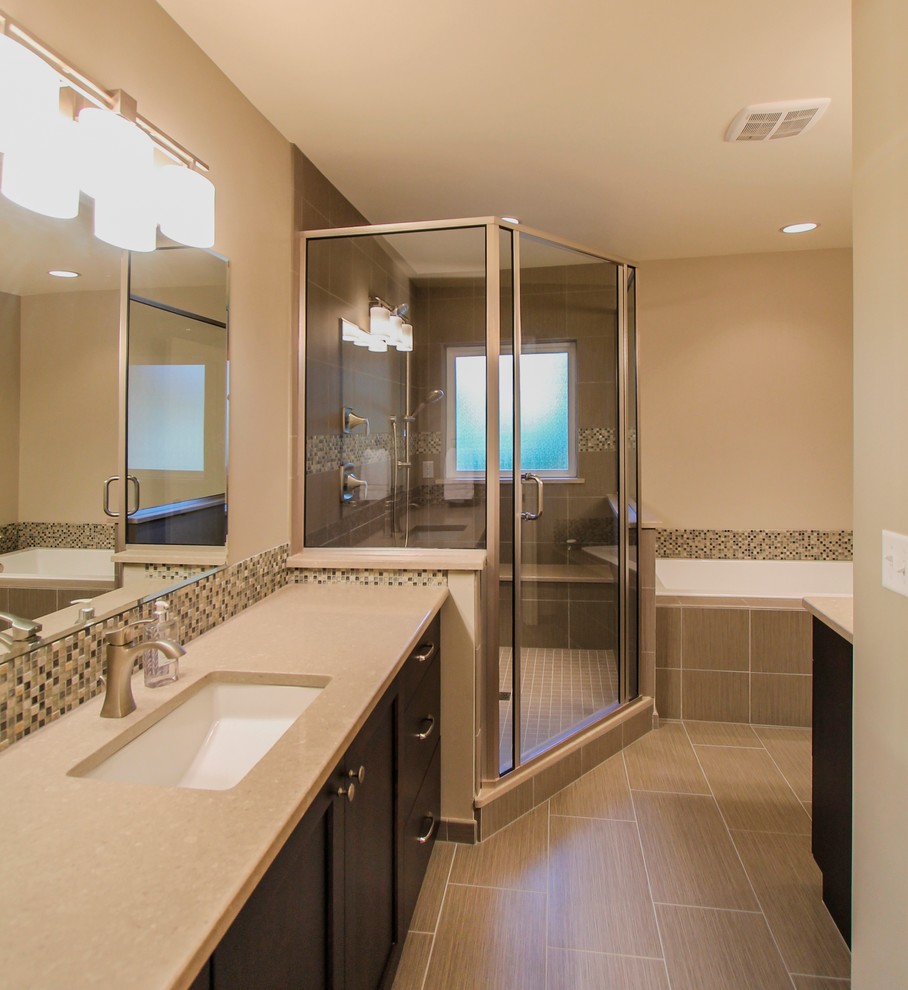 Design ideas for a large transitional master bathroom in Denver with an undermount sink, recessed-panel cabinets, dark wood cabinets, engineered quartz benchtops, a drop-in tub, a corner shower, multi-coloured tile, mosaic tile, beige walls and ceramic floors.