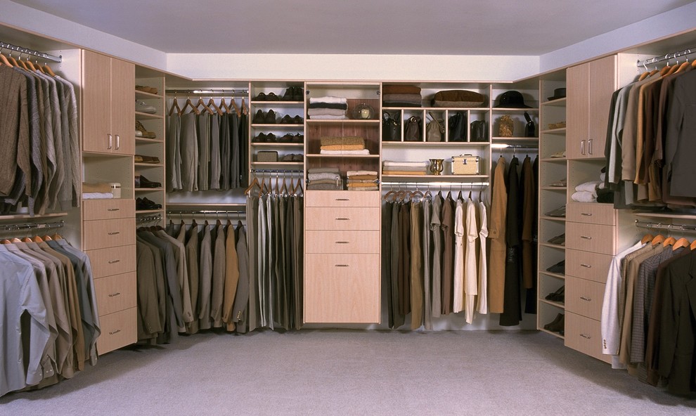 Photo of an expansive contemporary gender-neutral walk-in wardrobe in Phoenix with flat-panel cabinets, light wood cabinets and carpet.