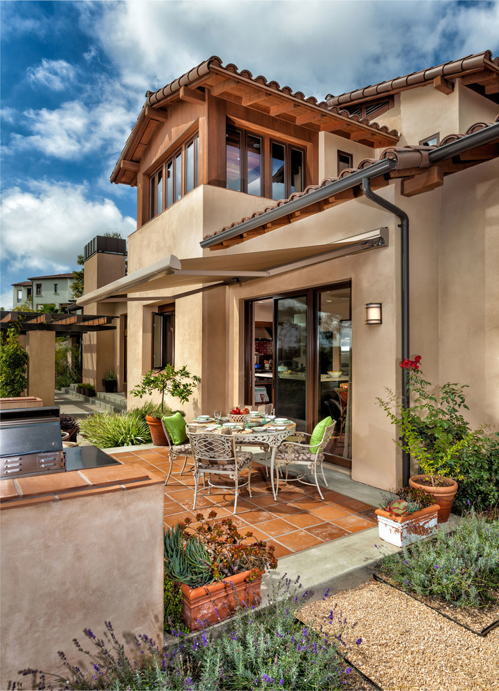 This is an example of a mediterranean patio in Orange County with an awning.