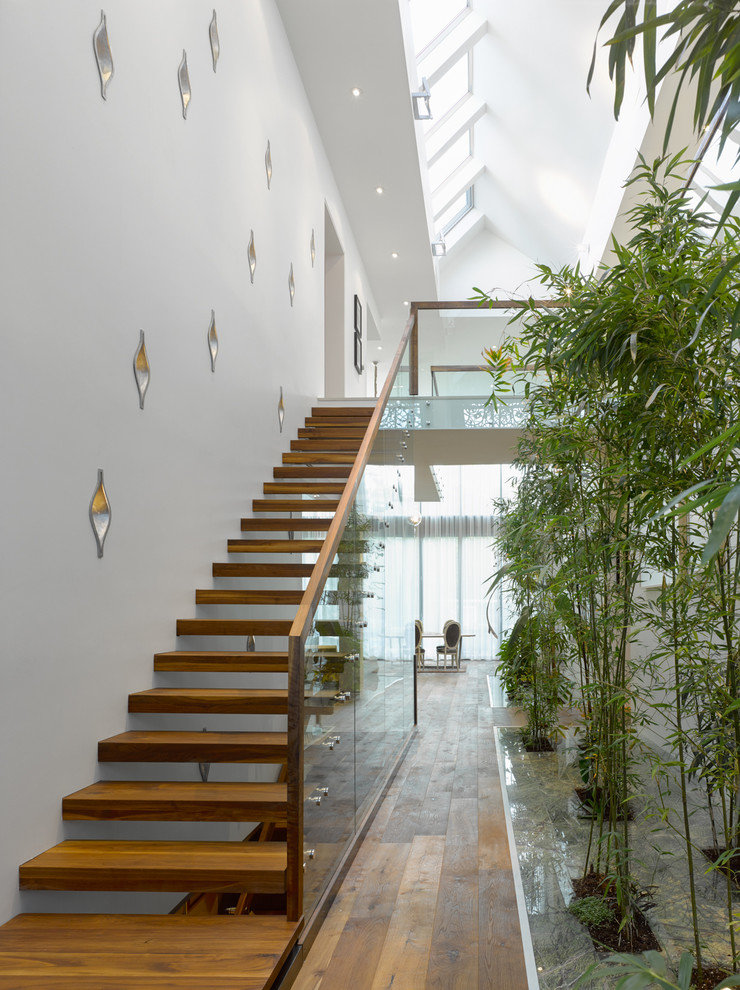 Inspiration for an expansive contemporary wood staircase in Toronto with open risers.