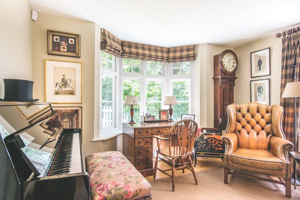 This is an example of a small traditional enclosed living room in Berkshire with beige walls, light hardwood floors, a wood stove, a stone fireplace surround and a built-in media wall.