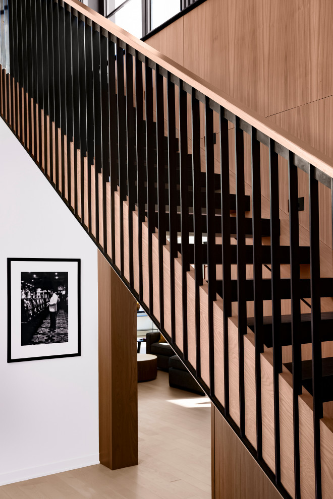 На фото: лестница среднего размера в современном стиле с деревянными ступенями и перилами из смешанных материалов без подступенок