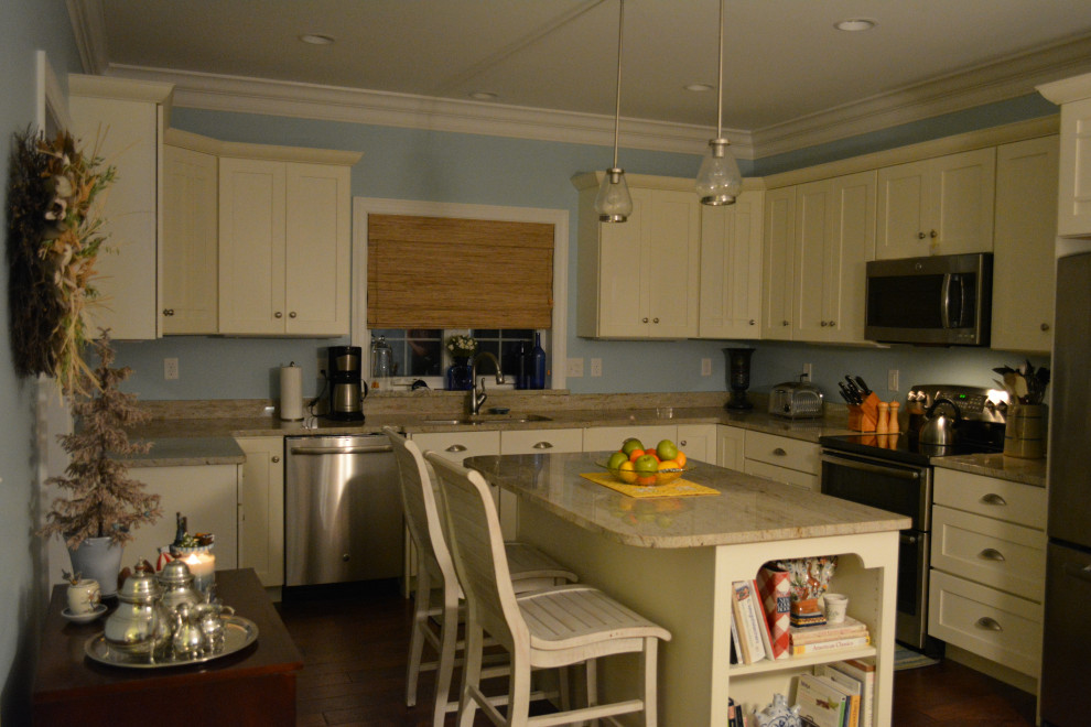 Mid-sized transitional u-shaped medium tone wood floor kitchen photo with a double-bowl sink, shaker cabinets, beige cabinets, granite countertops, stainless steel appliances, an island and beige countertops