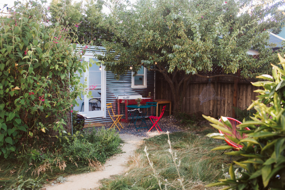 This is an example of a small modern backyard partial sun xeriscape for spring in San Francisco with a vegetable garden and decomposed granite.