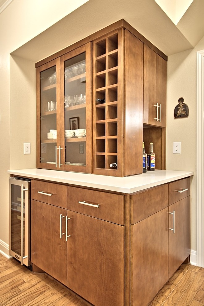Inspiration for a small modern single-wall wet bar in Austin with flat-panel cabinets, brown cabinets, medium hardwood floors, quartz benchtops, brown floor and white benchtop.
