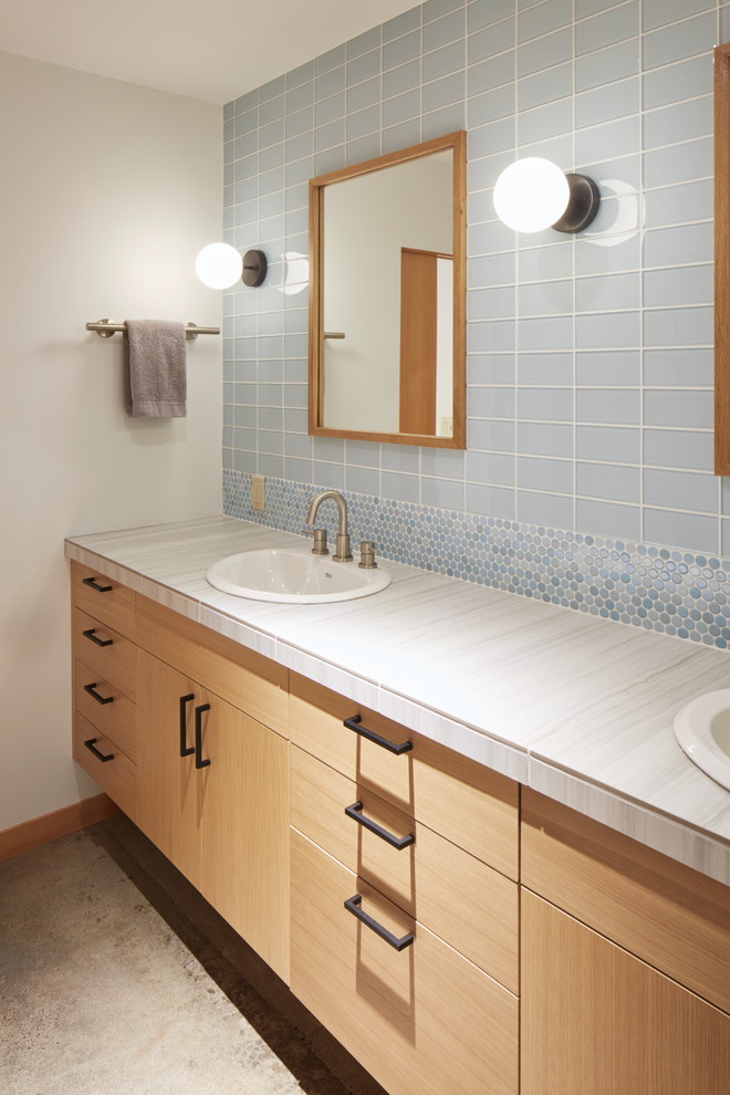 Design ideas for a large contemporary kids bathroom in Portland with flat-panel cabinets, light wood cabinets, blue tile, glass tile, white walls, concrete floors, a drop-in sink, tile benchtops and grey floor.
