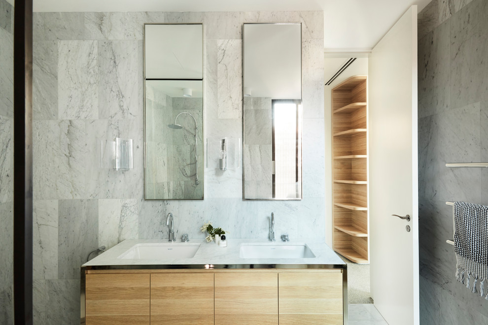 This is an example of a modern master bathroom in Sydney with flat-panel cabinets, medium wood cabinets, white tile, white walls, an undermount sink, white floor and white benchtops.
