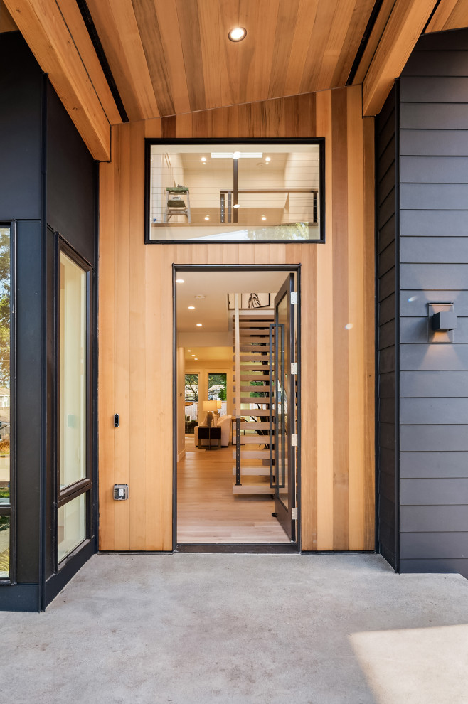 Идея дизайна: входная дверь среднего размера в стиле модернизм с черными стенами, светлым паркетным полом, одностворчатой входной дверью и черной входной дверью