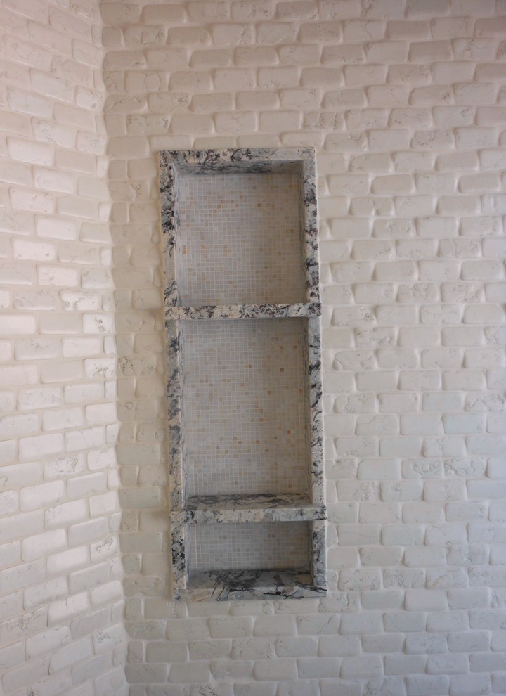 Large mountain style master beige tile and stone tile pebble tile floor walk-in shower photo with granite countertops