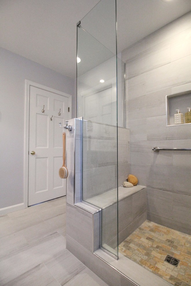 Inspiration for a mid-sized transitional master gray tile and porcelain tile porcelain tile corner shower remodel in Boston with shaker cabinets, dark wood cabinets, a two-piece toilet, gray walls, an undermount sink and quartz countertops