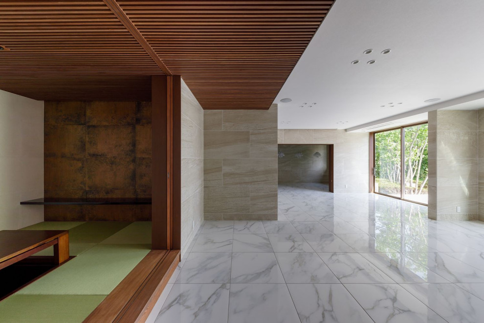 This is an example of a large world-inspired formal enclosed living room feature wall in Osaka with beige walls, ceramic flooring, a wall mounted tv, white floors, a wood ceiling and panelled walls.