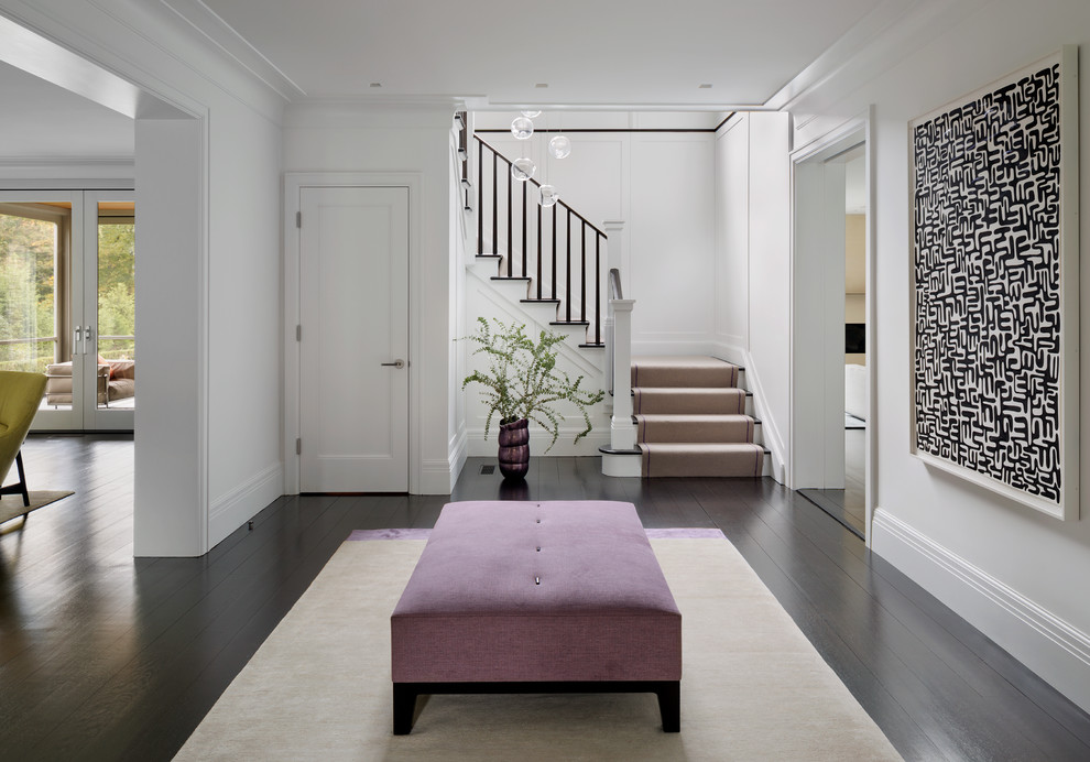 Inspiration for a large modern hallway in New York with dark hardwood floors and white walls.
