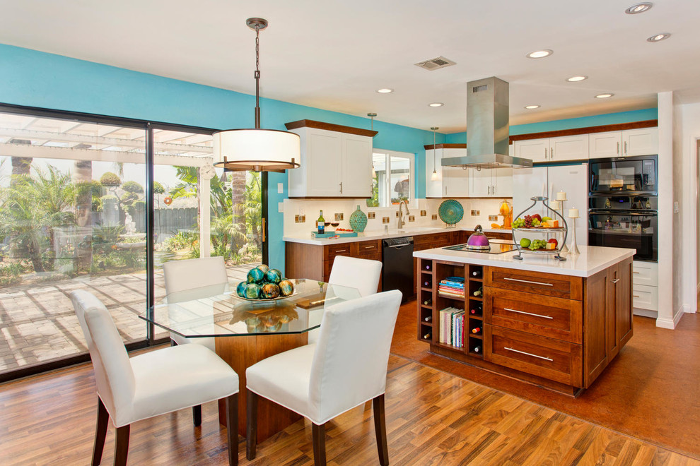 Inspiration for a large contemporary l-shaped open plan kitchen in San Diego with shaker cabinets, an undermount sink, white cabinets, quartz benchtops, white splashback, subway tile splashback, black appliances, cork floors and with island.