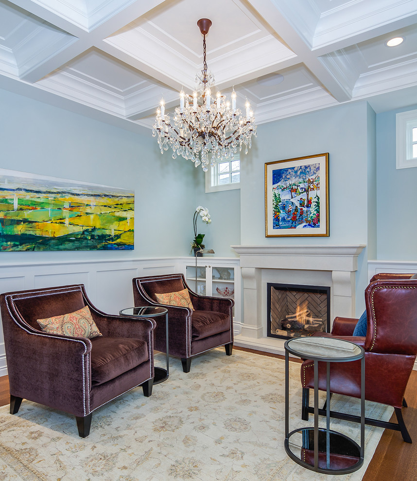 Traditional living room in Calgary with blue walls, medium hardwood floors, a standard fireplace, a stone fireplace surround and no tv.