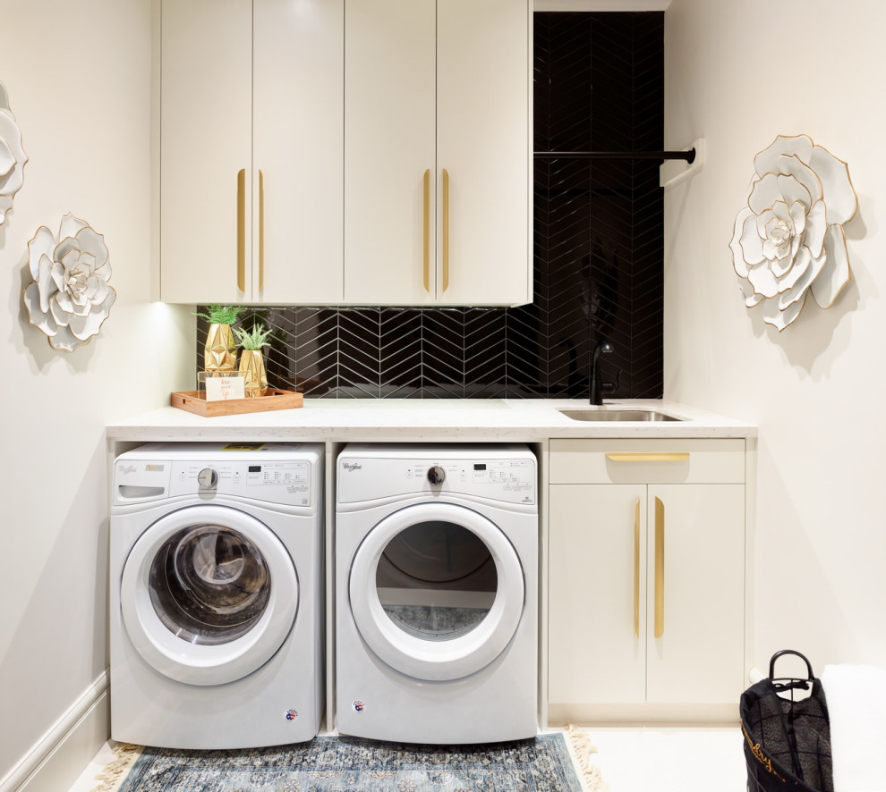Design ideas for a small contemporary single-wall dedicated laundry room in Vancouver with a single-bowl sink, flat-panel cabinets, white cabinets, quartz benchtops, white walls, porcelain floors, a side-by-side washer and dryer, white floor and white benchtop.