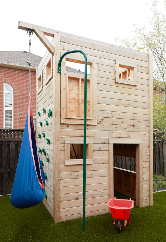Design ideas for a transitional full sun garden in Toronto with with outdoor playset.