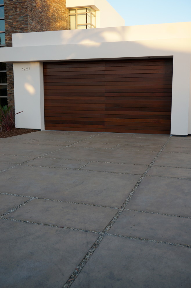 Photo of a mid-sized modern front yard full sun driveway in Santa Barbara with concrete pavers.