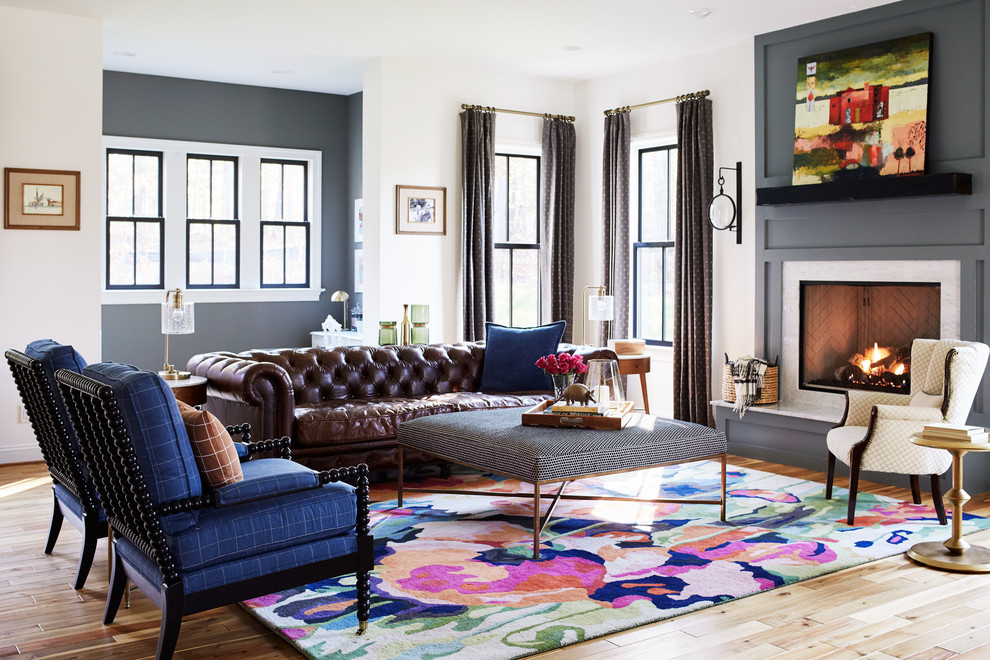 Photo of an eclectic living room in Richmond with multi-coloured walls, light hardwood floors, a standard fireplace, a stone fireplace surround and beige floor.