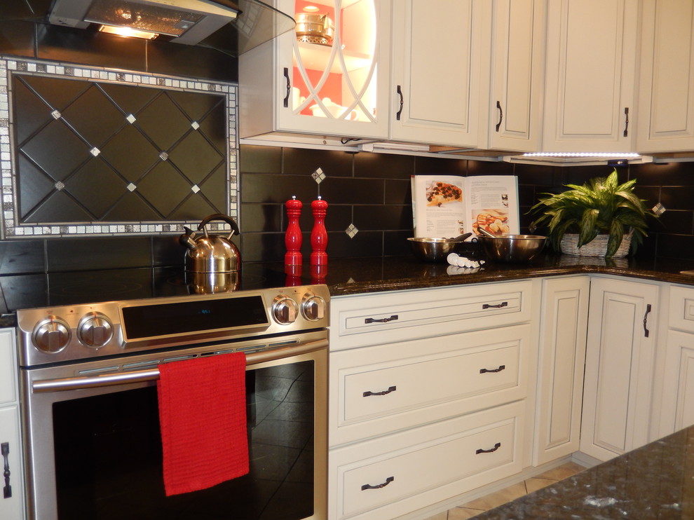 Inspiration for a mid-sized transitional u-shaped ceramic tile eat-in kitchen remodel with a double-bowl sink, raised-panel cabinets, white cabinets, granite countertops, black backsplash, subway tile backsplash, stainless steel appliances and an island