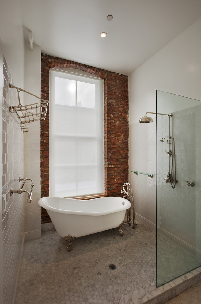 This is an example of a mid-sized industrial 3/4 bathroom in New York with a claw-foot tub, an open shower, white tile, subway tile, an open shower, white walls, marble floors and grey floor.