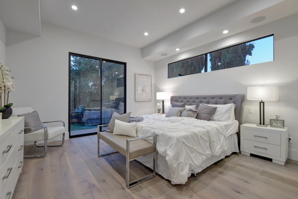 Mid-sized contemporary master bedroom in San Francisco with white walls, light hardwood floors and beige floor.