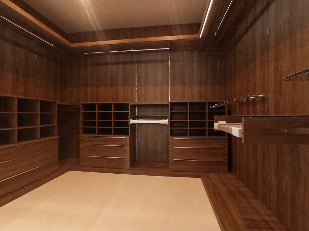 Medium sized contemporary walk-in wardrobe in Other with flat-panel cabinets, medium wood cabinets, ceramic flooring and beige floors.